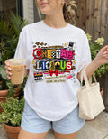 Cheetahlicious Collage T-Shirt | Retro Cassette Leopard Print Colorful Lettering Graphic Tee