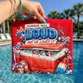 May include: Red graphic t-shirt with the text "SUMMER WAS LOUD AND WE LOVED IT". The design features a cooler filled with ice and cans, a popsicle, and patriotic stars and stripes. The shirt is held up by a person.